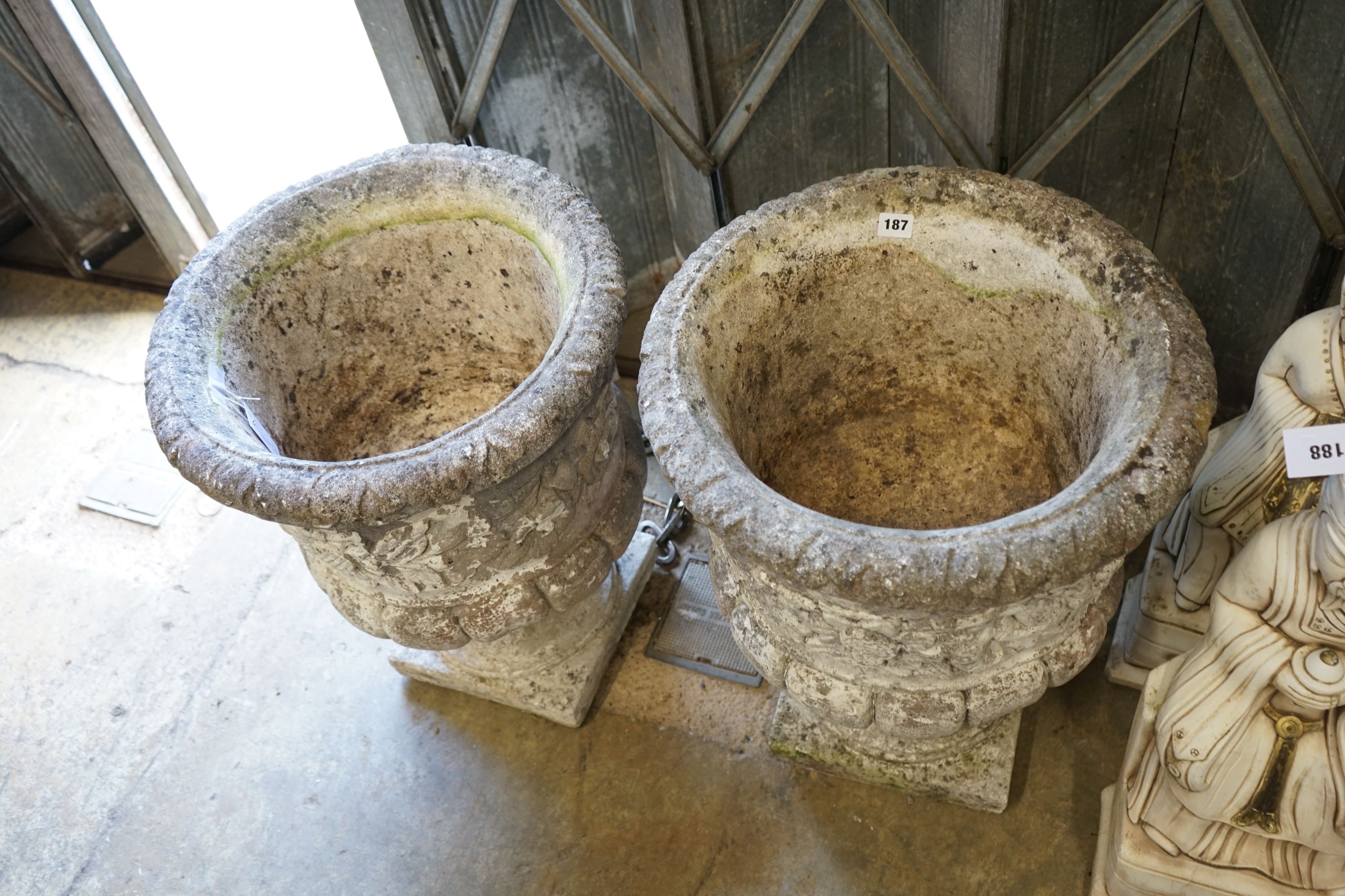 A pair of reconstituted stone campana garden urns, diameter 46cm height 60cm